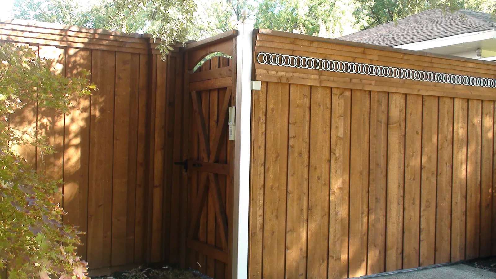 Electric gate with decorative rings and side gate — Fence Max Texas project