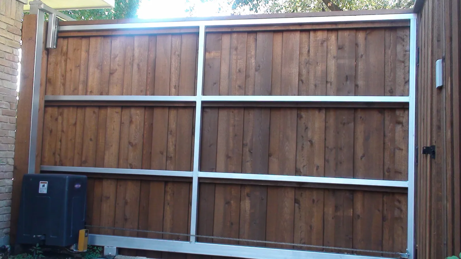 Electric gate with decorative rings back side view — Fence Max Texas project