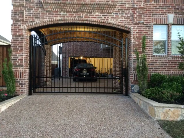 Iron electric gate inside arched brick — Fence Max Texas project
