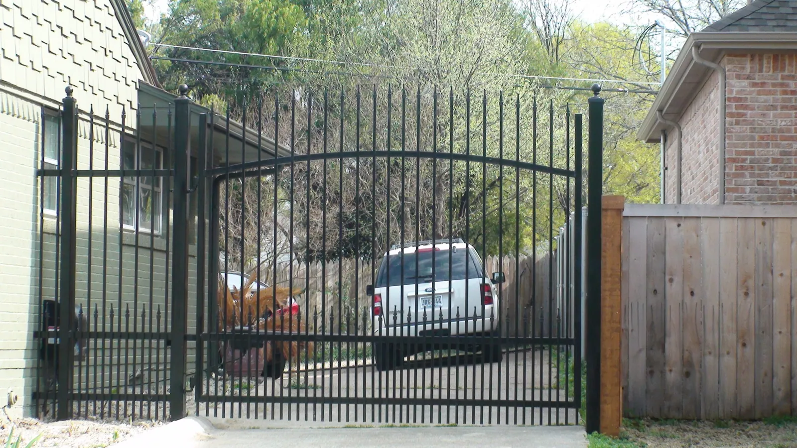 Iron electric swing gate extended pickets finials puppy panels — Fence Max Texas project