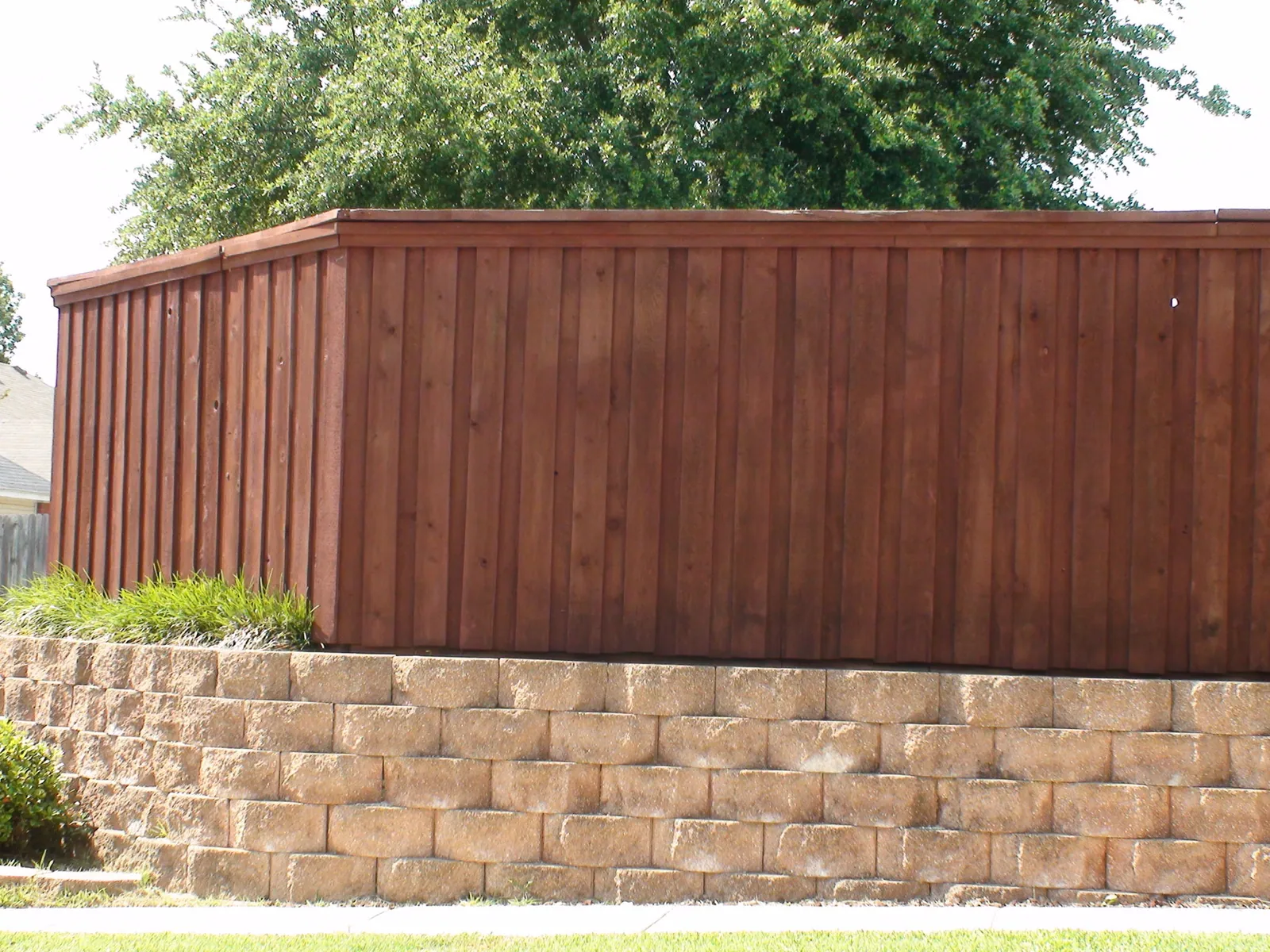Paver retaining wall with board on board fence