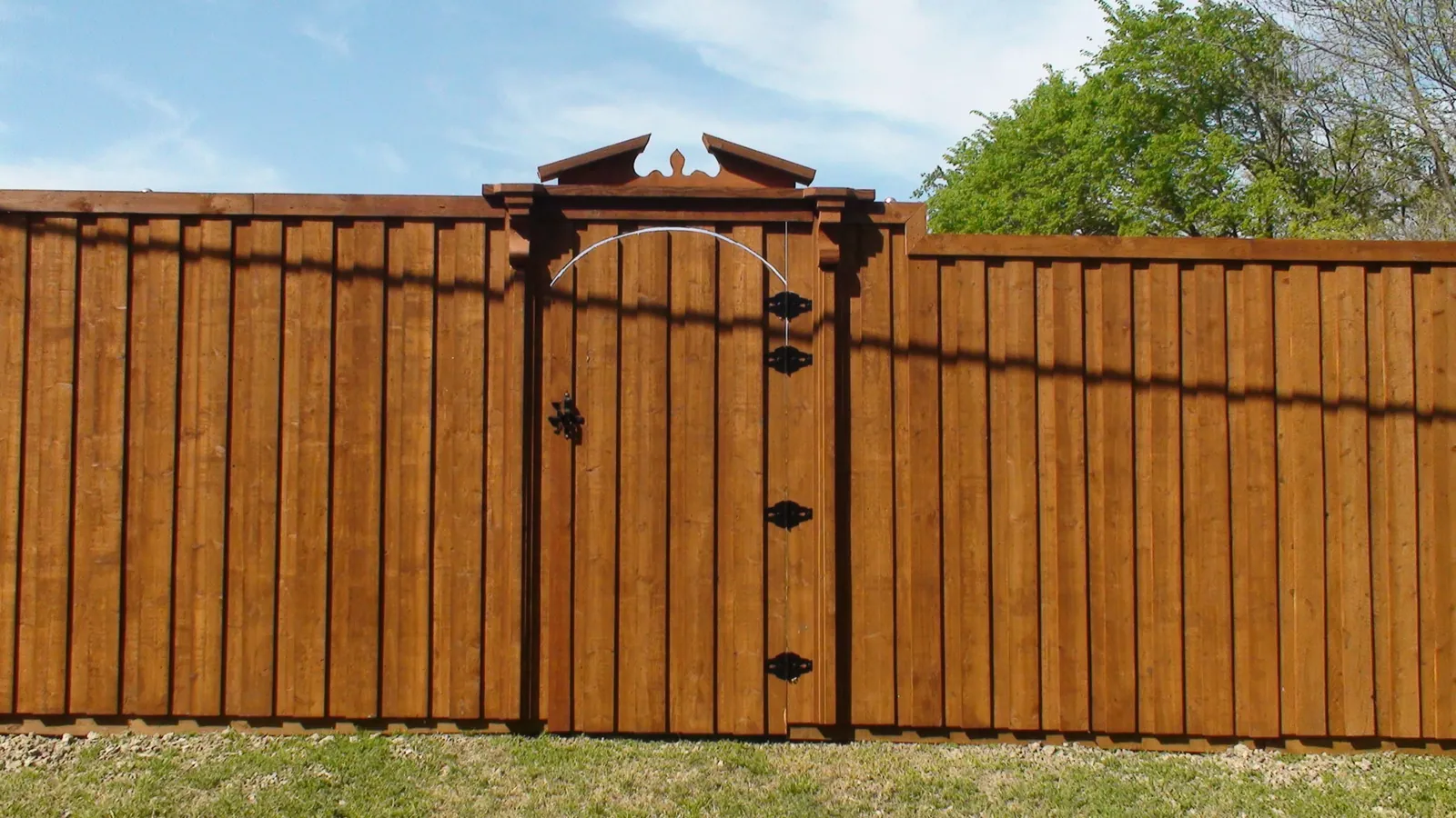 Board on board fence with trim gate with pediment top corbels