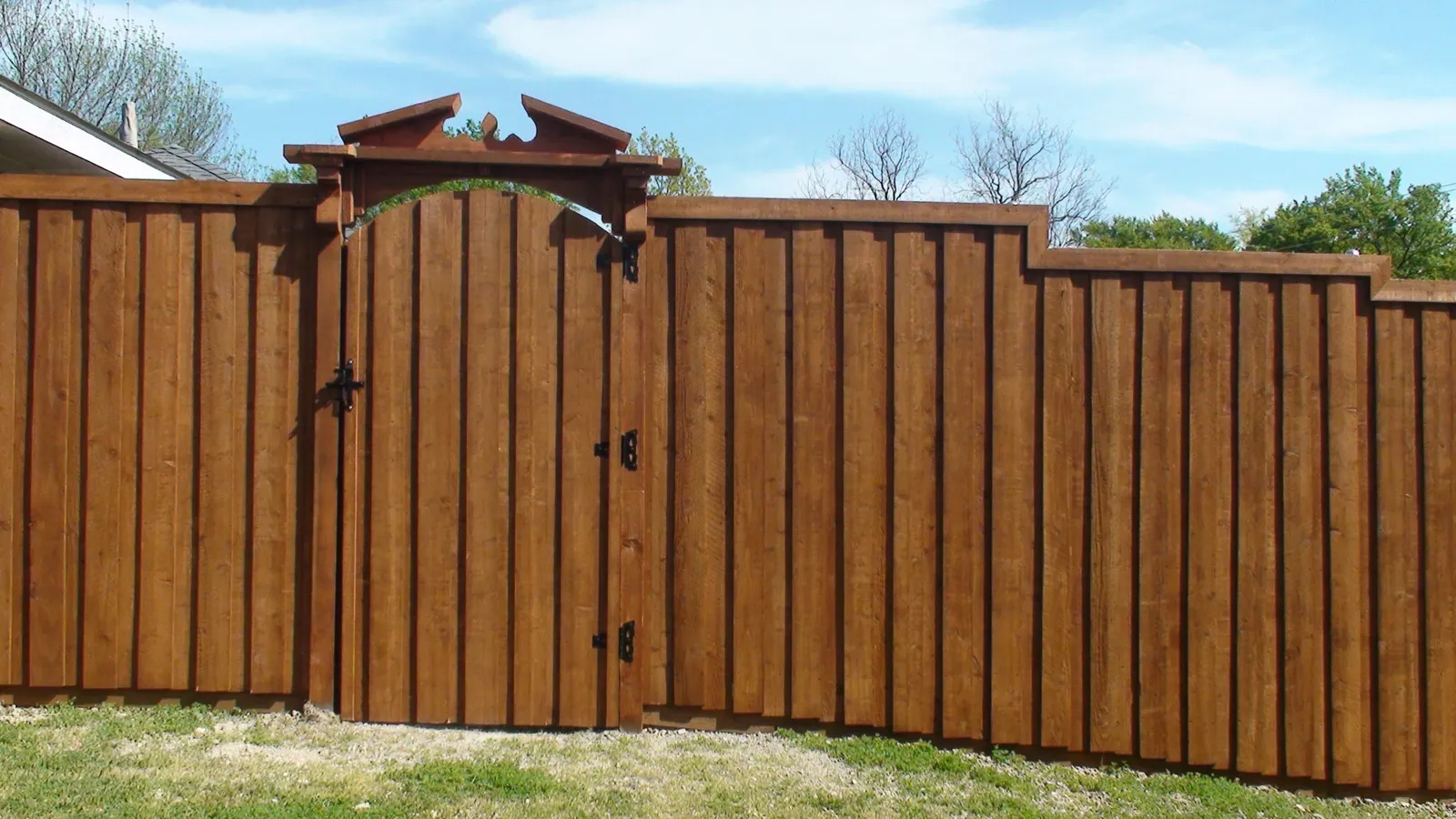 Board on board fence with trim gate with pediment top corbels