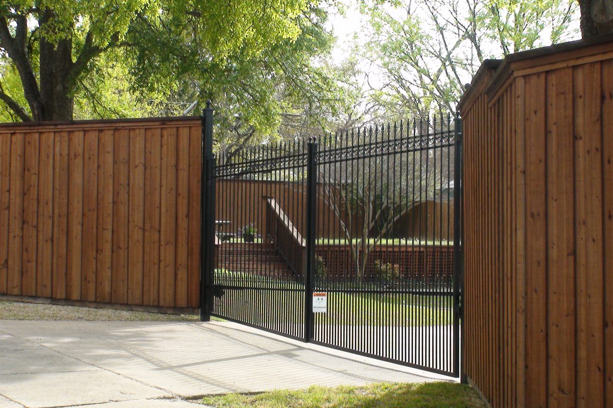 310 - Custom double iron swing gate - extended pickets. finials, puppy panels & b_b wood fence with double trim