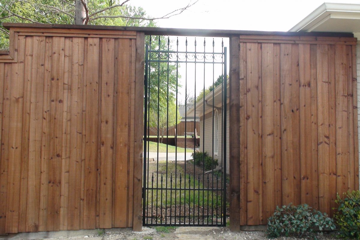 605 - Custom iron walk in gate on b_b wood fence