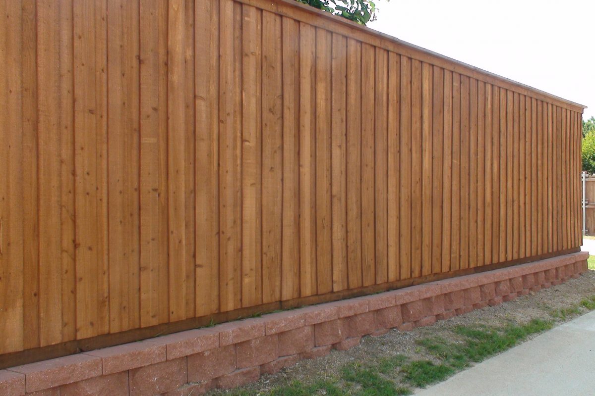 902 - Red paver retaining wall & board on board fence